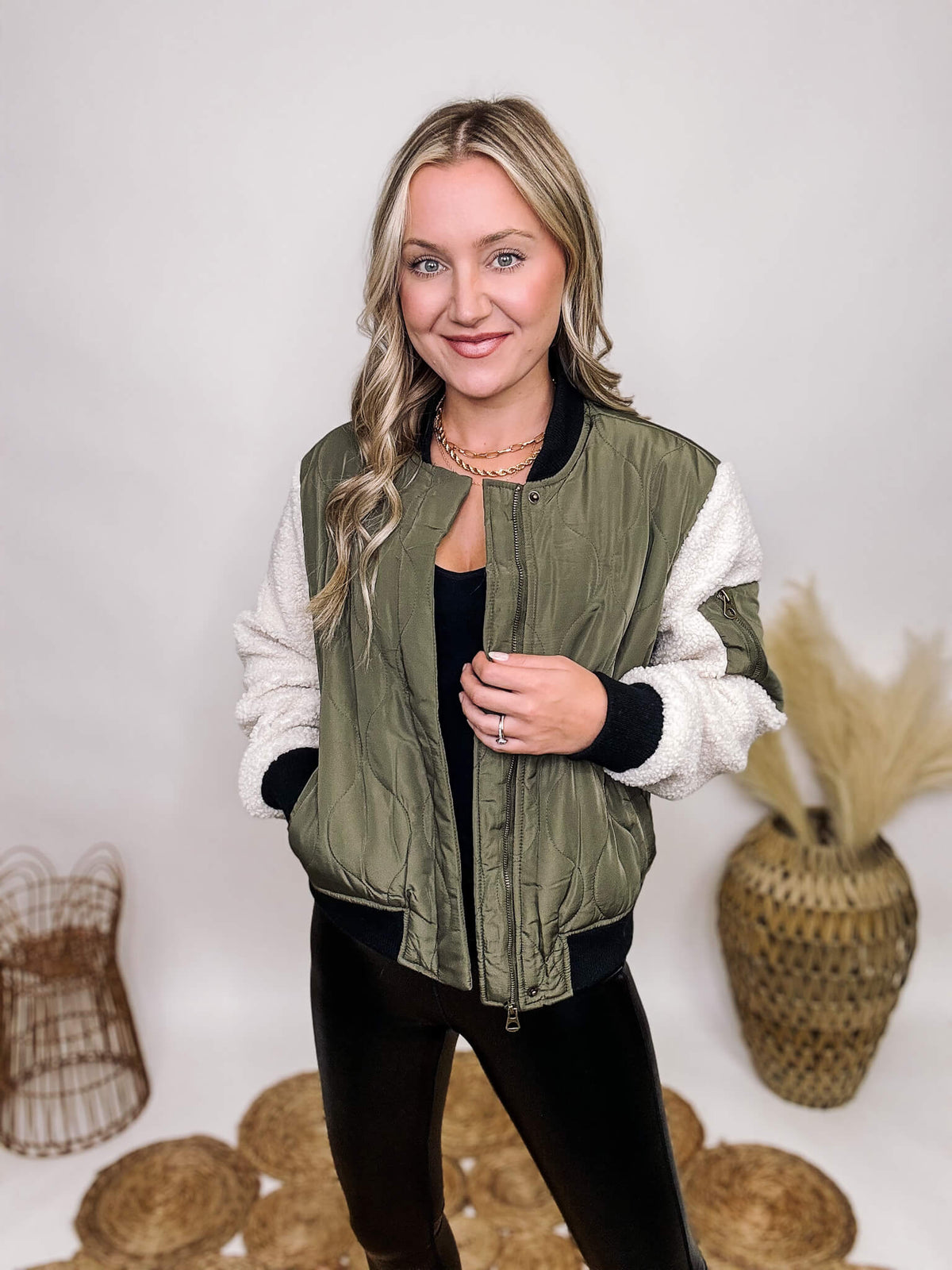 26 International Olive Green Quilted Bomber Jacket Sherpa Sleeves Side Pockets Zip Up with Top and Bottom Button Snaps Medium to Heavy Weight Relaxed Fit 100% Polyester