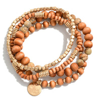 Brown Set of Four Stretch Bracelets Featuring Gold Toned and Wood Beads Approximately 2.5" DBrown Set of Four Stretch Bracelets Featuring Gold Toned and Wood Beads Approximately 2.5" D