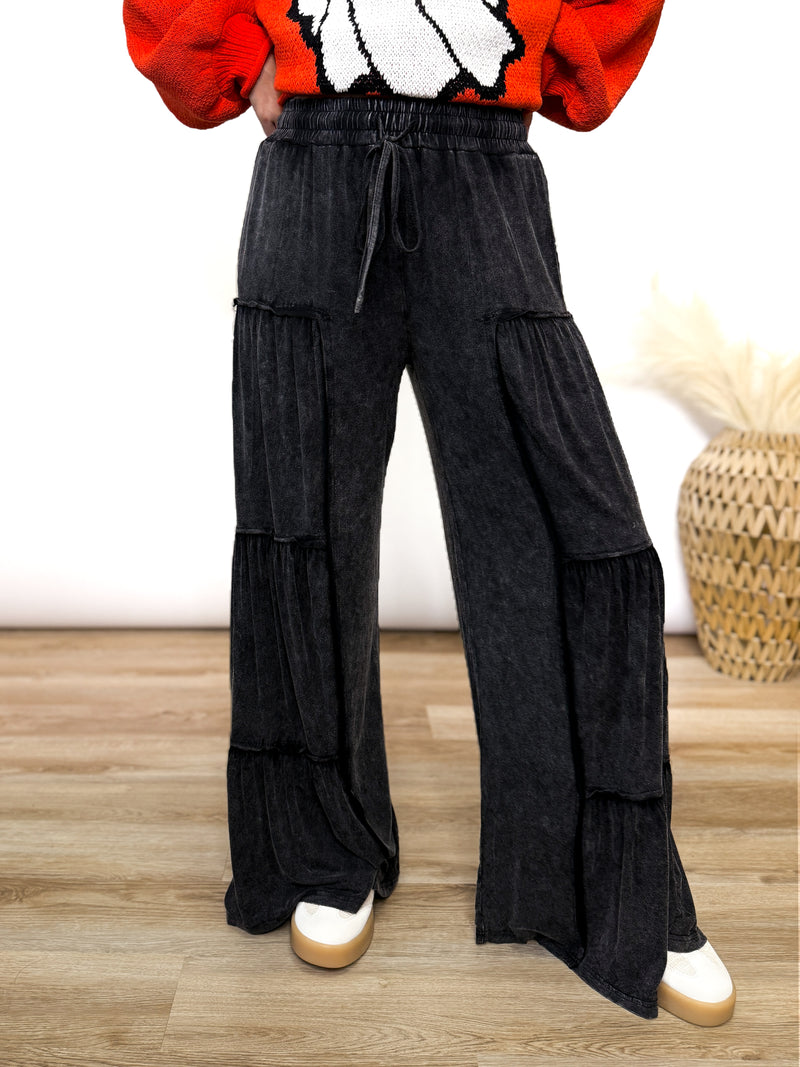 Black acid washed tiered flared wide leg boho pants with elastic drawstring waist and side pockets. Soft cotton, perfect for dressing up or down.
