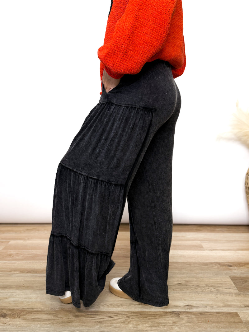 Black acid washed tiered flared wide leg boho pants with elastic drawstring waist and side pockets. Soft cotton, perfect for dressing up or down.