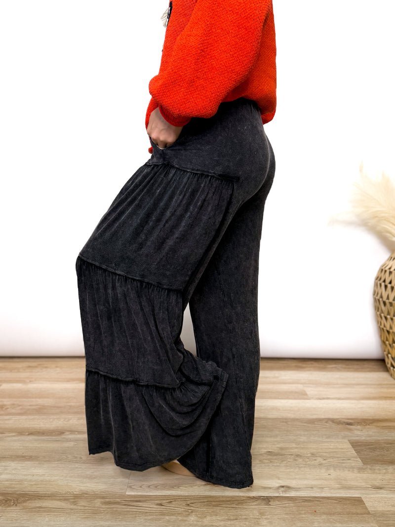 Black acid washed tiered flared wide leg boho pants with elastic drawstring waist and side pockets. Soft cotton, perfect for dressing up or down.