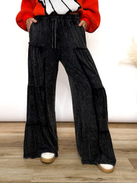 Black acid washed tiered flared wide leg boho pants with elastic drawstring waist and side pockets. Soft cotton, perfect for dressing up or down.
