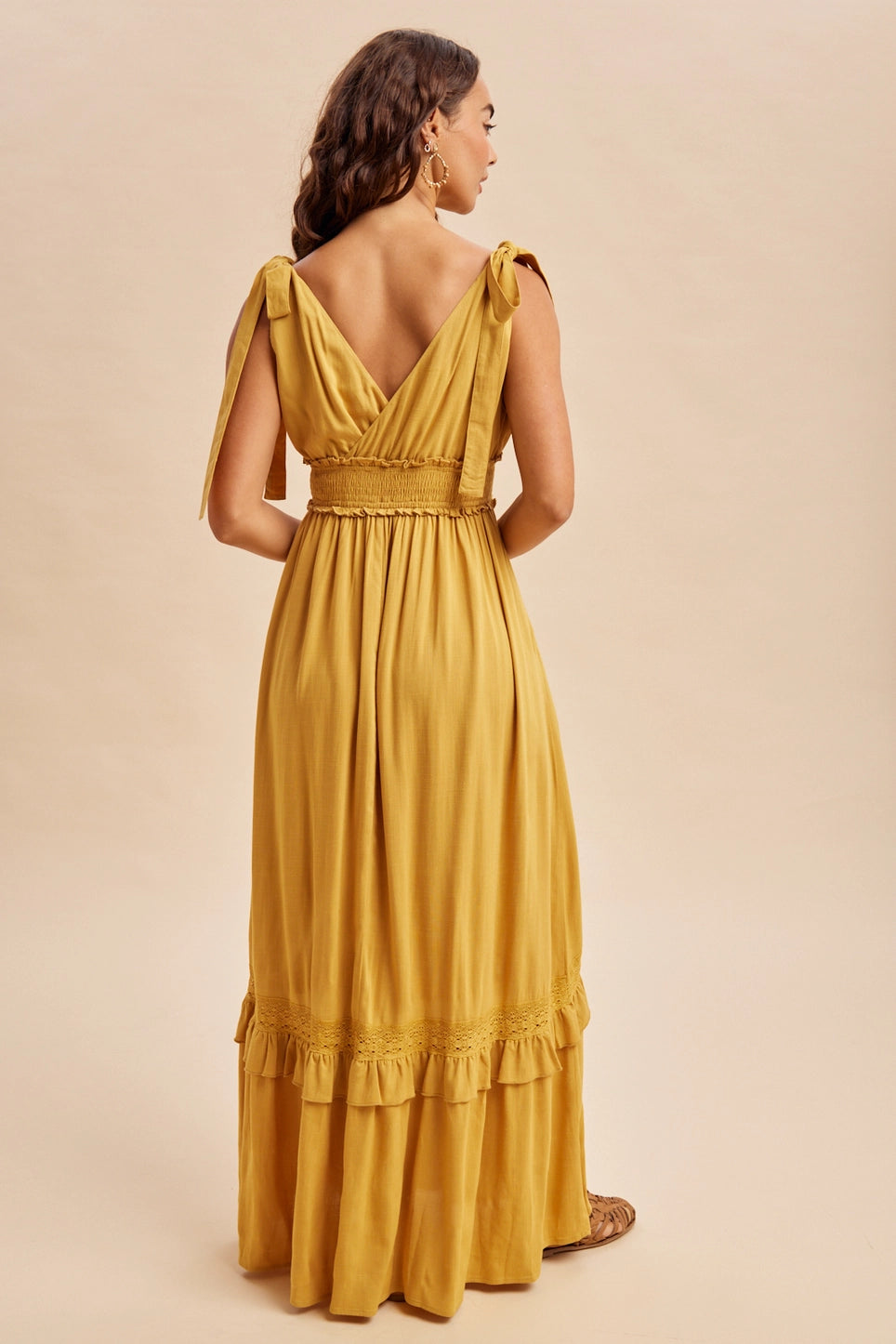 Women’s mustard yellow boho summer dress with ruffle and lace accents, pockets and ruffle details with self tying straps and smocked stretchy waist.