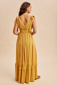 Women’s mustard yellow boho summer dress with ruffle and lace accents, pockets and ruffle details with self tying straps and smocked stretchy waist.