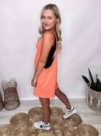 Ces Femme coral V-neck spaghetti strap romper with two pockets. Oversized and relaxed fit. Made from 85% cotton and 15% polyester.