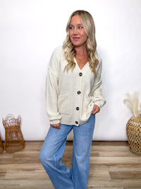 cream oversized button up cardigan with v neck and front pockets styled for fall layering
