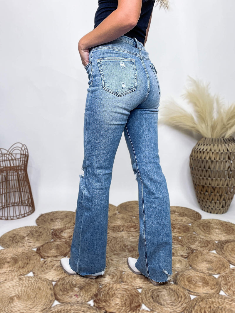 Medium Wash Risen Risen Denim Distressed Flare Jeans Raw Bottom Hem Stretchy Button and Zip Fly True to Size 95% Cotton, 3.5% Rayon, 1.5% Spandex 11" Rise, Approximately 31" Inseam