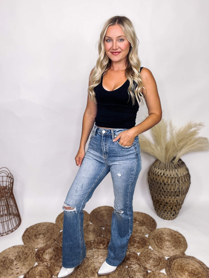 Medium Wash Risen Risen Denim Distressed Flare Jeans Raw Bottom Hem Stretchy Button and Zip Fly True to Size 95% Cotton, 3.5% Rayon, 1.5% Spandex 11" Rise, Approximately 31" Inseam