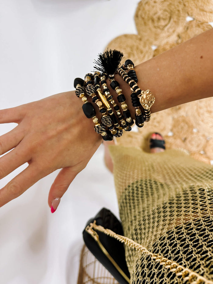 Set of Seven Beaded Stretch Bracelets Featuring Gold Tones And Black Beads