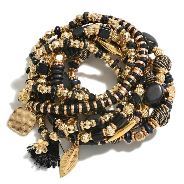 Set of Eight Beaded Stretch Bracelets Featuring Gold Tones And Black Beads