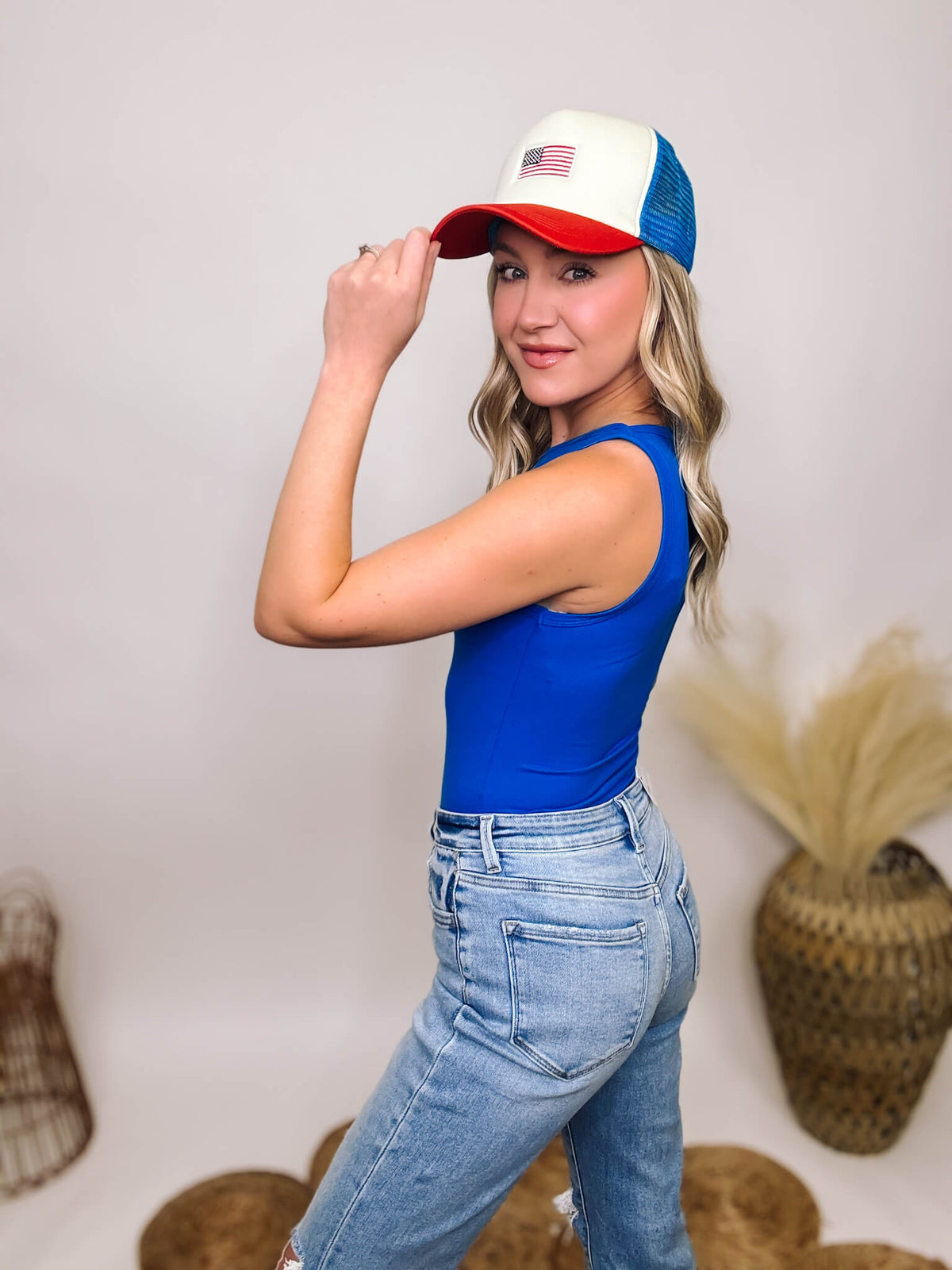 Zenana Blue Boat Neck Sleeveless Tank Bodysuit made from soft, comfortable fabric, perfect for versatile styling and pairing with the Red, White, and Blue American Flag Embroidered Trucker Hat
