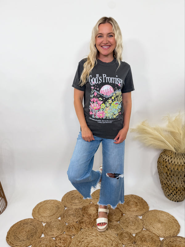 Shop the God’s Promises Graphic Tee in washed black at Bmaes Boutique. Floral sunset Christian tee with “God’s Promises Are Unshakeable” on soft Comfort Colors cotton.