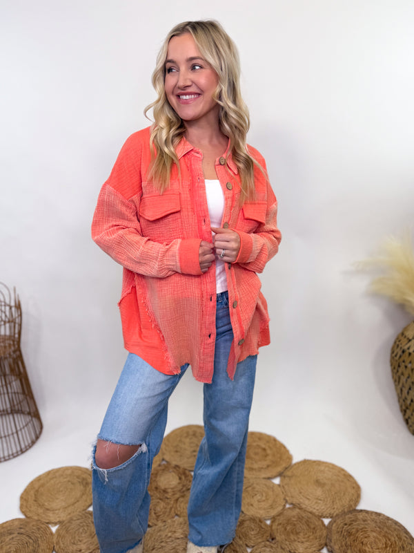 Coral mineral-washed oversized button-up shacket with a relaxed fit, raw edge details, and front patch pockets. Made from lightweight 100% cotton for a breathable and effortlessly stylish layering piece, perfect for spring and summer.