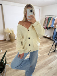 cream oversized button up cardigan with v neck and front pockets styled for fall layering