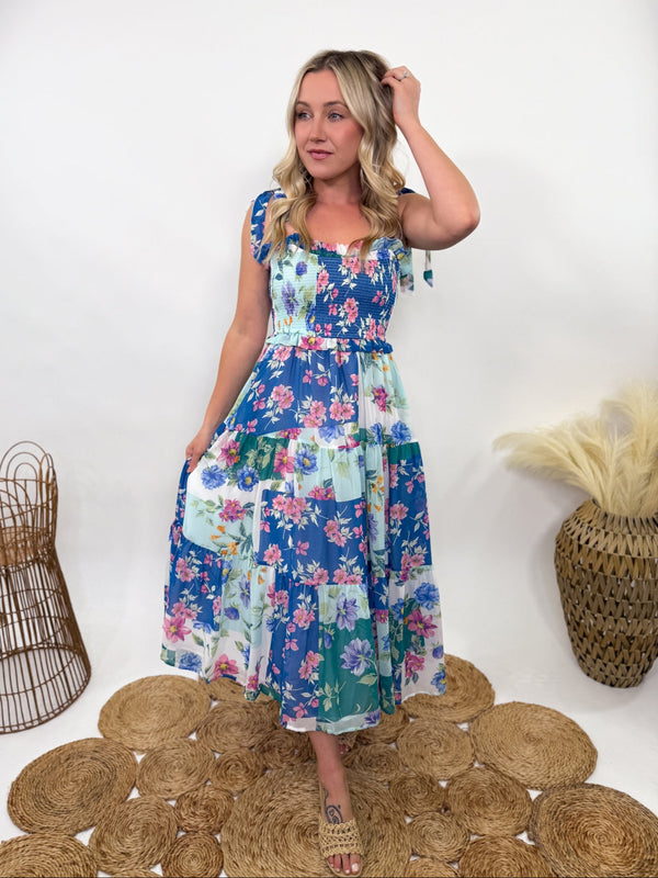 Blue Skies Vintage Floral Smocked Tiered Maxi Dress with Pocket – Ruffle sweetheart neckline, smocked stretchy fitted top, tiered flowy body, adjustable self-tying straps, side pockets, and fully lined. Perfect for spring and summer occasions like Easter, weddings, and baby showers. Bump-friendly and flattering for all body types.