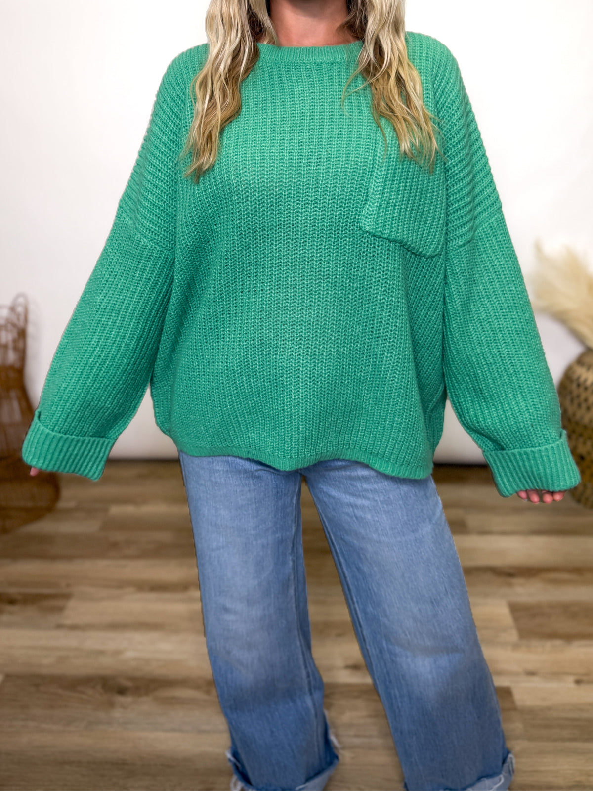 green oversized sweater with chest pocket and cuffed sleeves. 