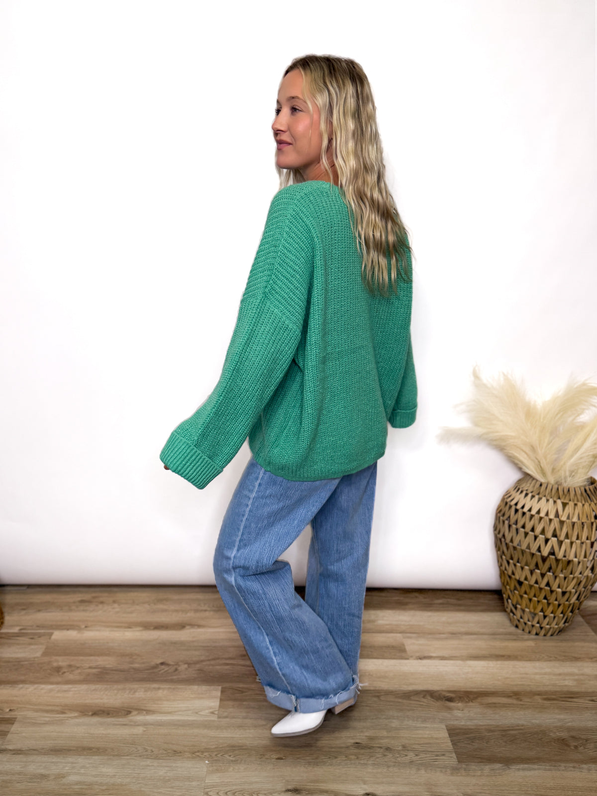 green oversized sweater with chest pocket and cuffed sleeves. 