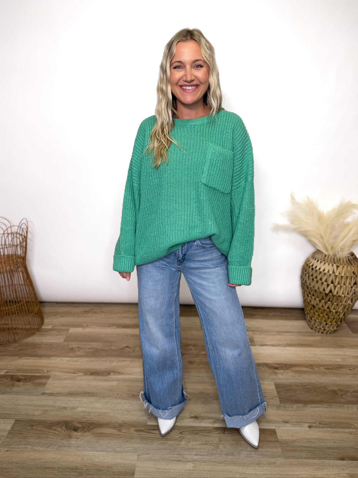 green oversized sweater with chest pocket and cuffed sleeves. 