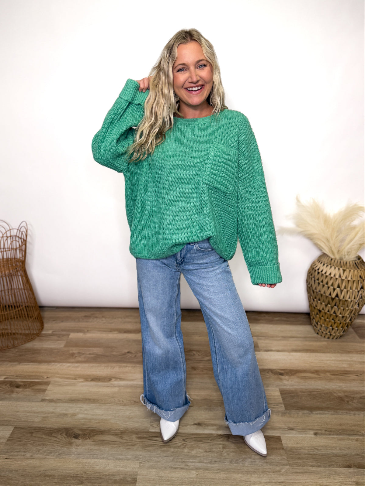 green oversized sweater with chest pocket and cuffed sleeves. 
