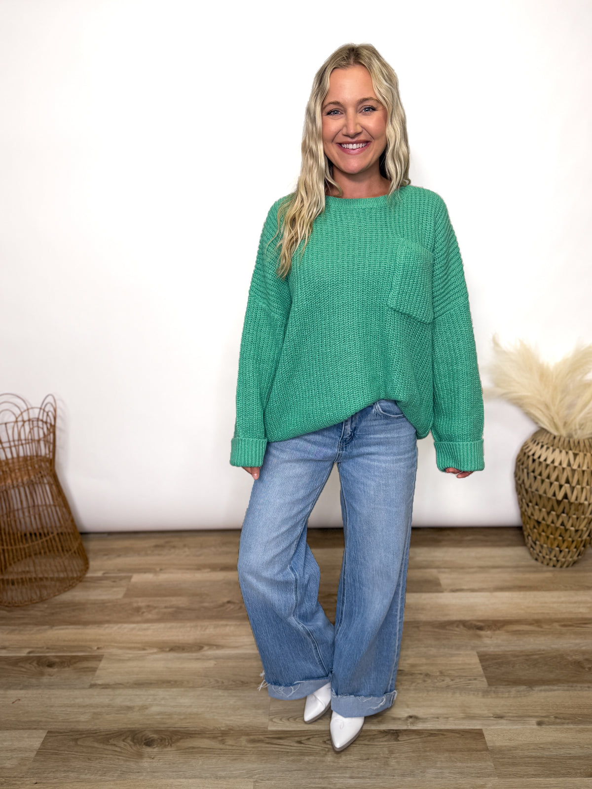 green oversized sweater with chest pocket and cuffed sleeves. 