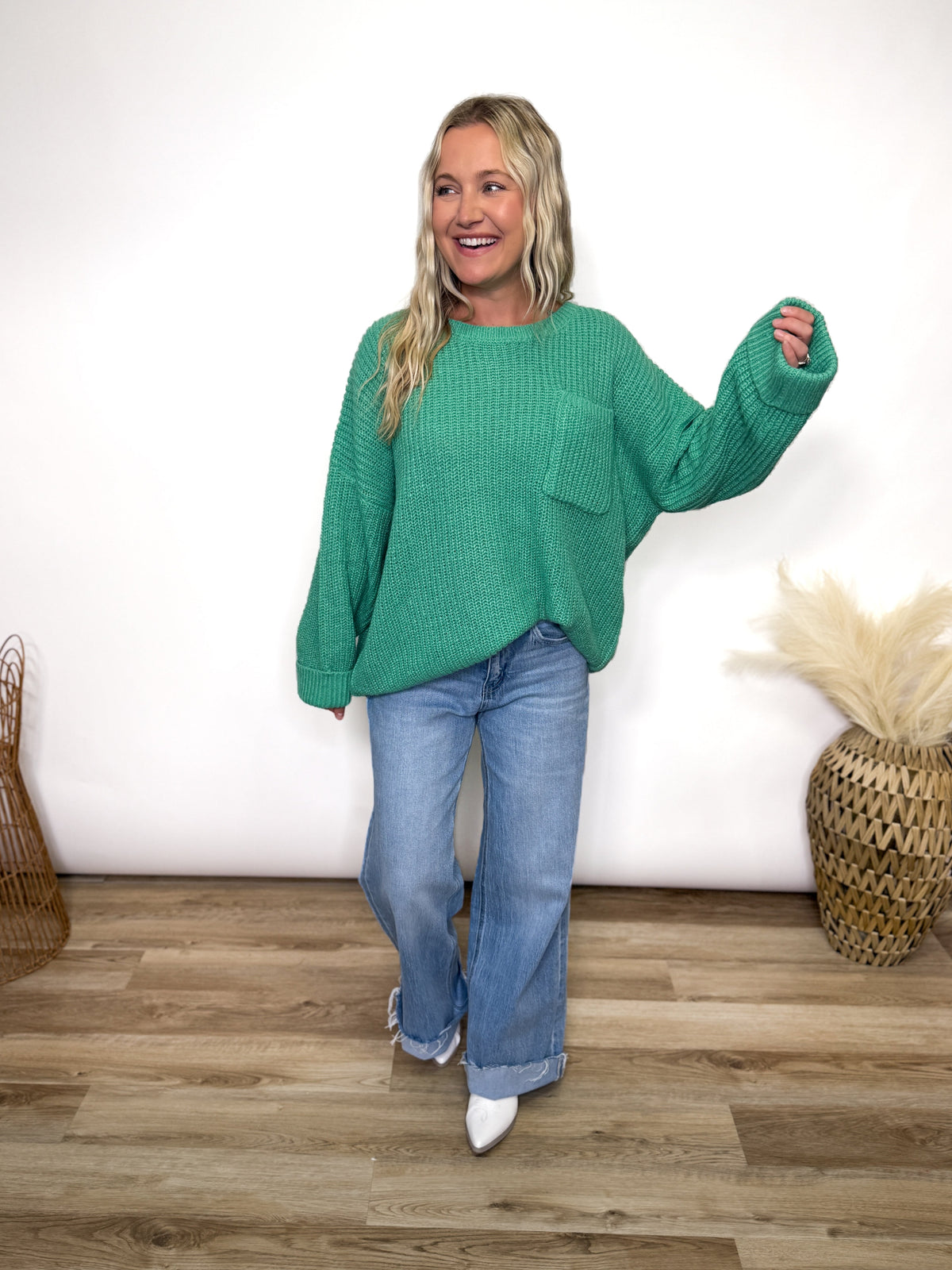 green oversized sweater with chest pocket and cuffed sleeves. 