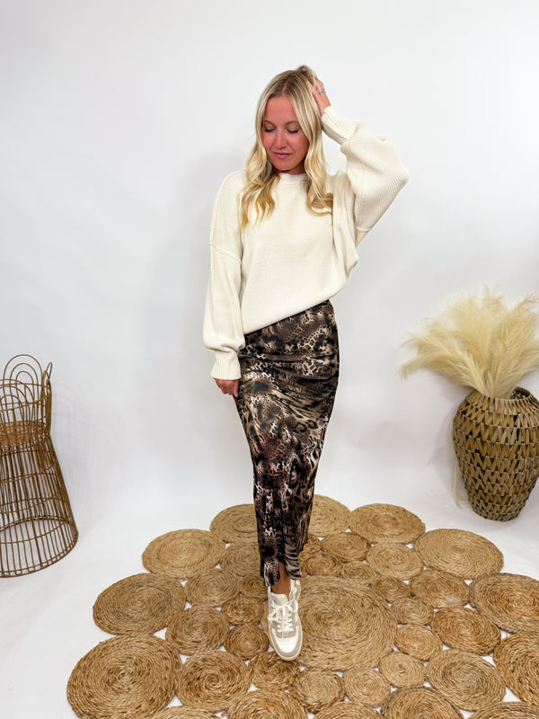 creamy sweater styled with leopard print maxi skirt and sneakers.