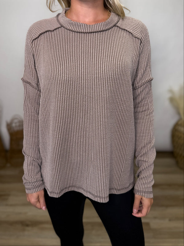 Neutral and versatile, this mocha ribbed long sleeve top is perfect for fall layering. Relaxed fit, exposed seams, and cozy stretch make it a wardrobe staple.