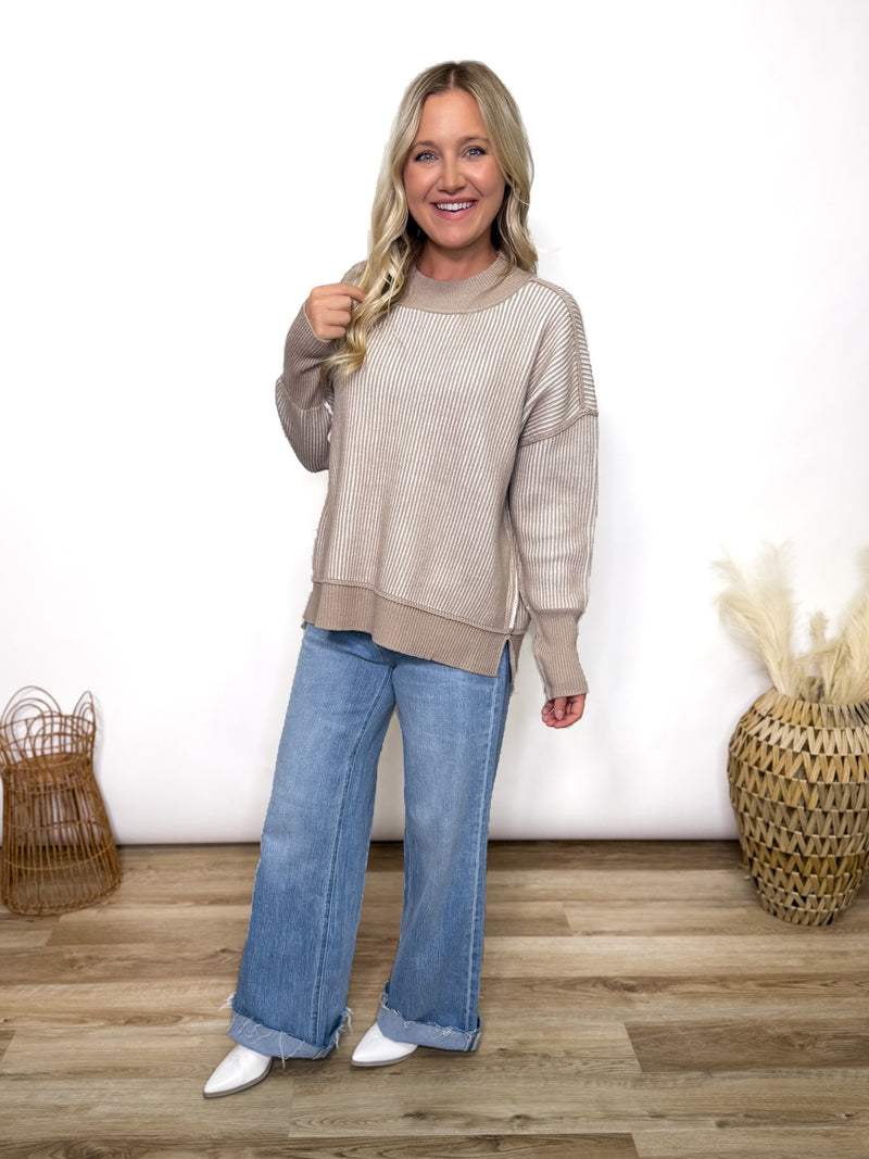 Cozy meets trendy in this neutral two tone ribbed sweater. Featuring exposed seams, side slits, and a relaxed fit. Perfect oversized fall to winter sweater.