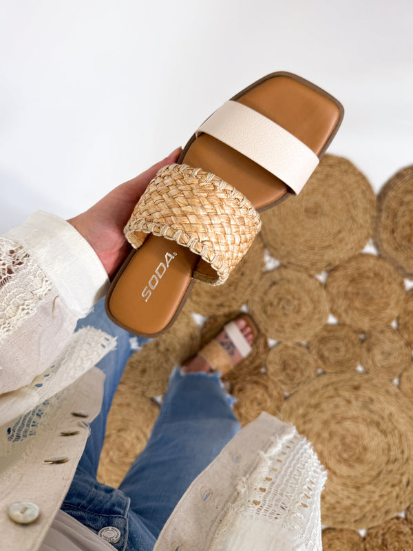 Close-up of Soda Raffia & Ivory Woven Double Strap Slide Sandals featuring textured woven raffia straps, an ivory band, and a trendy square toe design. Women's spring and summer sandals. 