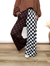 Split Decisions Checker Print Wide Leg Pants half brown/black, half black/white. Stretchy ribbed wide leg pants with elastic waistband and side pockets styled with oversized pullover and sneakers