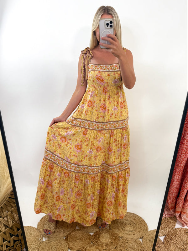 Yellow floral boho maxi dress with adjustable tie straps and tiered fit