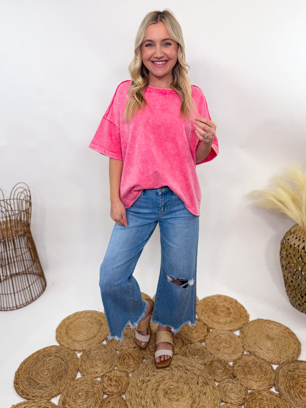 Fuchsia pink acid-washed oversized French terry tee with a raw hem and vintage-inspired fade. Soft 100% cotton fabric, relaxed fit, and breathable feel. Perfect for casual, sporty, or everyday styling.