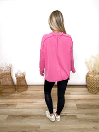 fuchsia ribbed long sleeve top with exposed seams and relaxed fit
