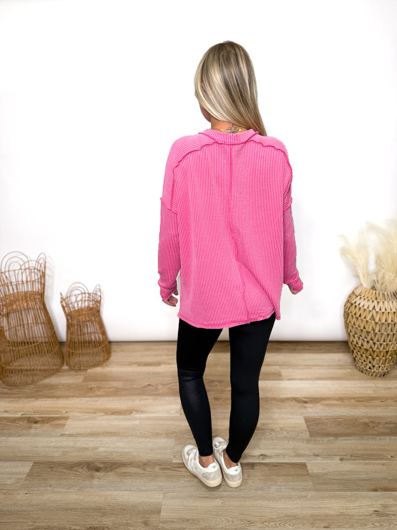 fuchsia ribbed long sleeve top with exposed seams and relaxed fit