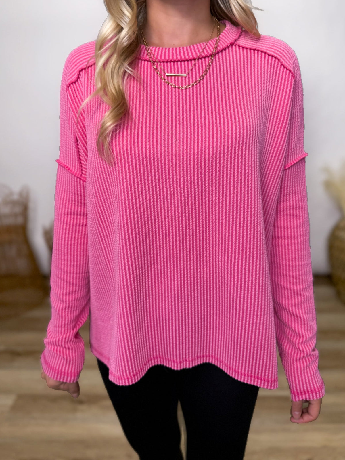 fuchsia ribbed long sleeve top with exposed seams and relaxed fit