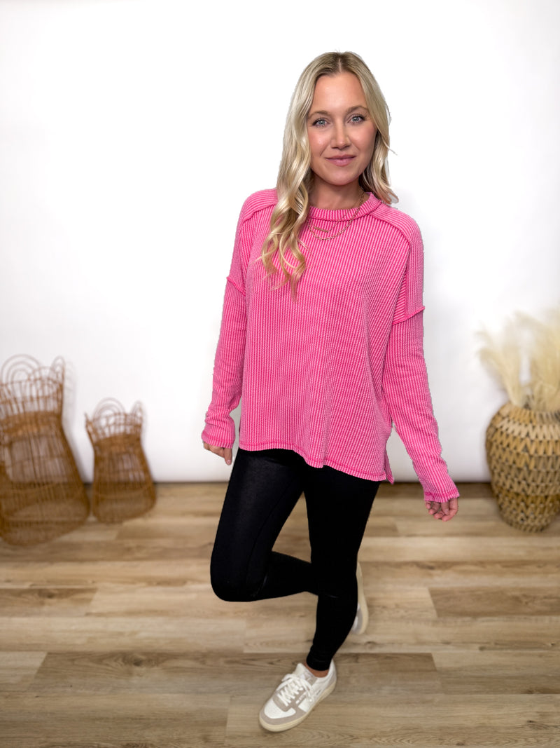 fuchsia ribbed long sleeve top with exposed seams and relaxed fit